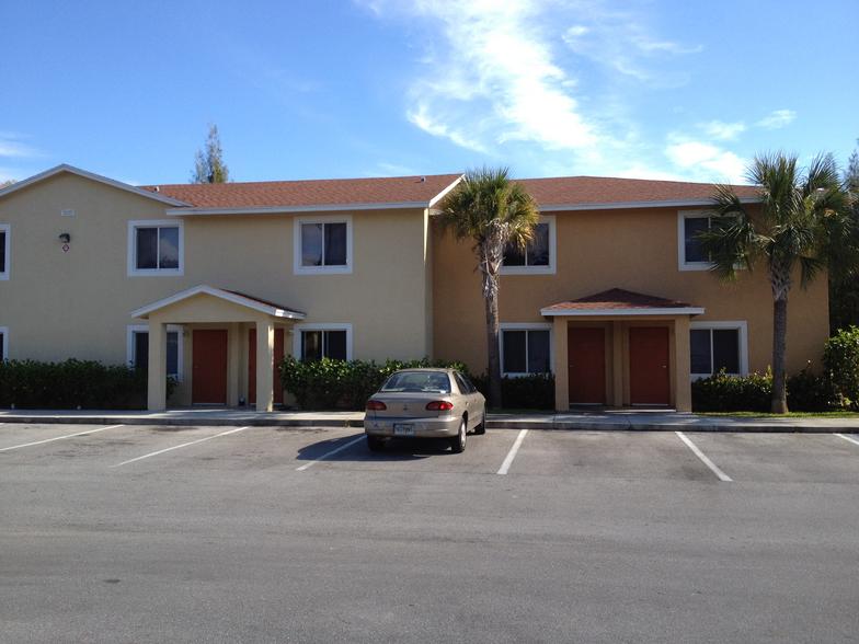 Two-story Cortez Village townhomes with private entries and palm trees