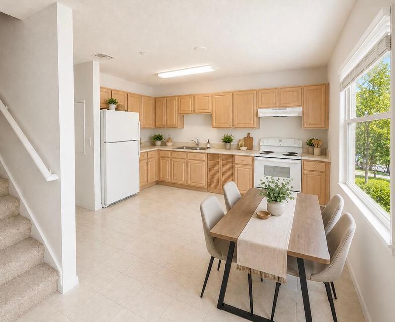 Townhome kitchen and dining area with full appliances and stairway